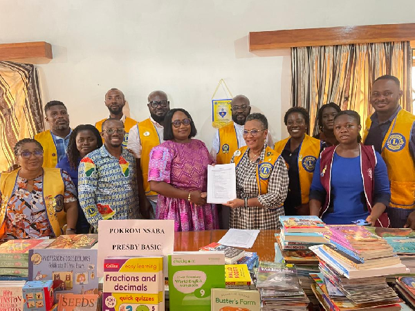 Dr. Helena Asamoah-Hassan and members of the club presenting the books to one of the schools