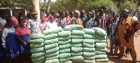The MP presenting bags of cement to the schoool