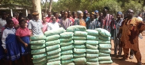 The MP presenting bags of cement to the schoool