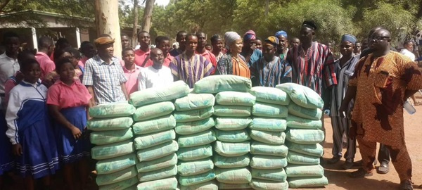 The MP presenting bags of cement to the schoool