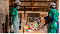 Medical staff enter a quarantine area in Lobaya, CAR following an outbreak the monkeypox virus