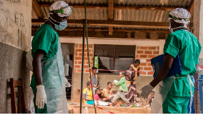 Medical staff enter a quarantine area in Lobaya, CAR following an outbreak the monkeypox virus