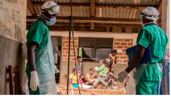 Medical staff enter a quarantine area in Lobaya, CAR following an outbreak the monkeypox virus