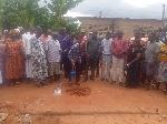 The NGO cuts sod to begin the construction of the classroom