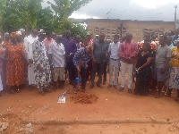 The NGO cuts sod to begin the construction of the classroom