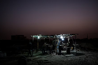 Maka Keila, 27, and Garry Ndajy, 32, work at an open-air brick workshop