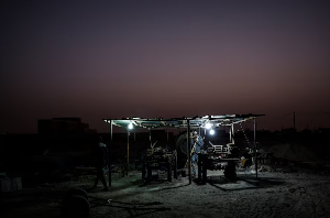 Maka Keila, 27, and Garry Ndajy, 32, work at an open-air brick workshop