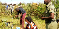 Police detectives at the scene in Kasebuti Village, where Moses Kimbowa's body was found