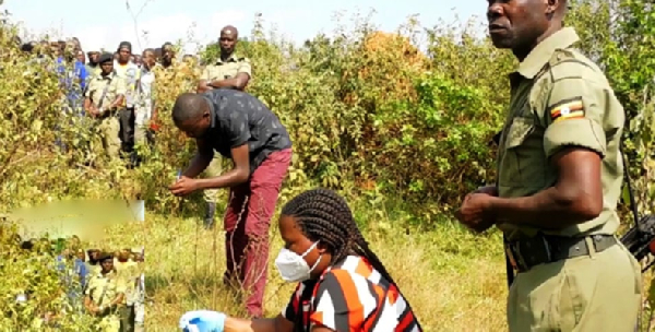 Police detectives at the scene in Kasebuti Village, where Moses Kimbowa's body was found