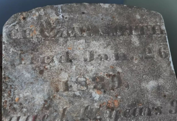 A tombstone dated 1839 is displayed at the recently rediscovered burial ground in New York