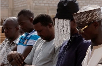 Undercover journalist Anas Aremeyaw Anas prays with others for his slain colleague Ahmed Suale