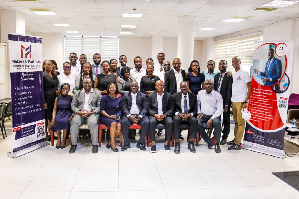 Mr Robert Nii Aryee Tackie in a pose with management of Makers and Partners, and participants