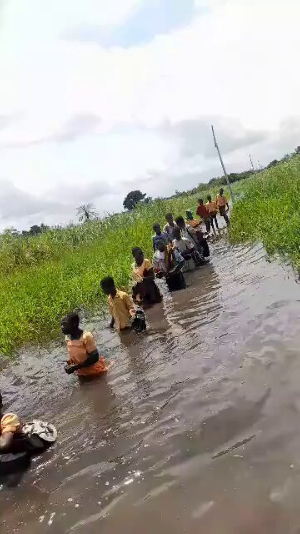 Children of Lawoshime risk their lives through water to get to school