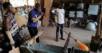 Michael Tetteh (Middle) is a professional glassblower