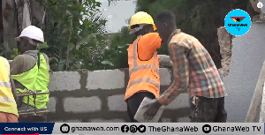 Masons working to replace the damaged blocks and restore the wall to its original state