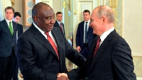 South Africa's President Cyril Ramaphosa (L) shaking hands with Russian President Vladimir Putin (R)