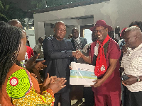 John Mahama (left) receiving the cheque