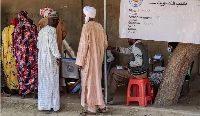 People wait to cast votes during the constitutional referendum at a polling station in N'Djamena