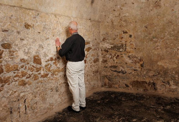 Archbishop of Canterbury Justin Welby prays in a Cape Coast Castle dungeon