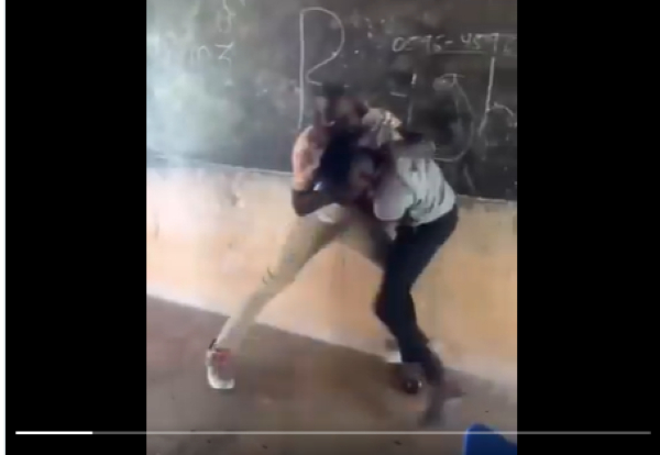 Two male teachers fighting in the classroom