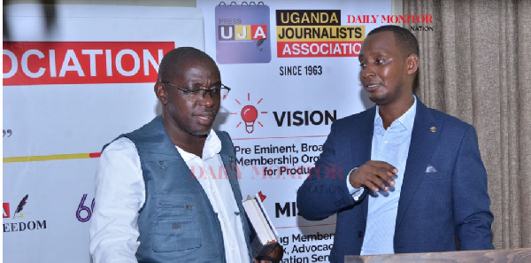 EC pokesperson Julius Mucunguzi and Mathias Rukundo, the president of Uganda Journalist Association