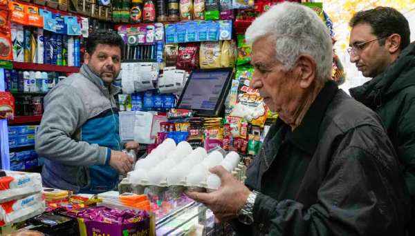 A man shops for eggs at a grocery store in northern Tehran, Iran
