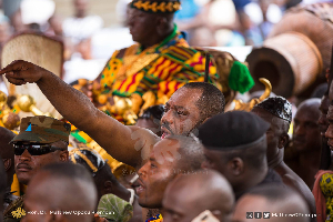 Dr. Matthew Opoku Prempeh (foreground with hand raised) and Otumfuo Osei Tutu II (background)
