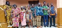 Members of the OKRA Project Ghana posing in front of the six-unit classroom block