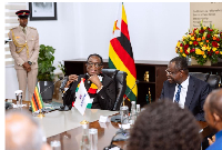 The President of Zimbabwe, Emmerson Mnangagwa (L) speaking during the meeting