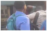 Commuters struggling to board a bus during peak hours