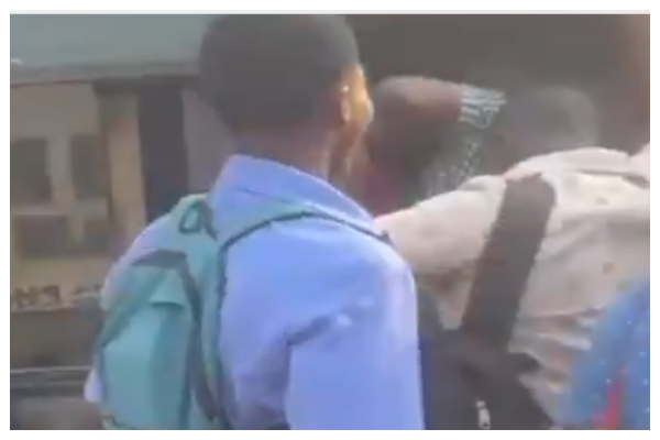 Commuters struggling to board a bus during peak hours