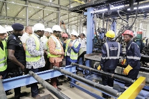 Alan Kyerematen with some dignitaries at a factory