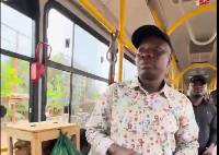 A photo of Mahama Ayariga standing in the Ayalolo bus