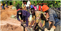 Artisanal miners load gold-bearing ore into sacks for transportation at Bukana Gold Mines