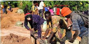 Artisanal miners load gold-bearing ore into sacks for transportation at Bukana Gold Mines
