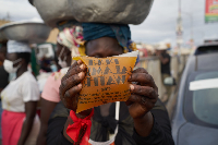 One of the traders displaying the packaged galamsey water