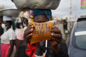 One of the traders displaying the packaged galamsey water