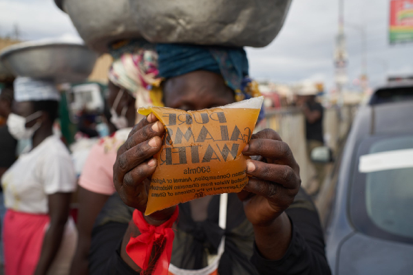 One of the traders displaying the packaged galamsey water