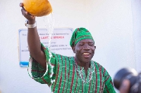 Lamtiig Apanga with a calabash of water after the inaugurationover