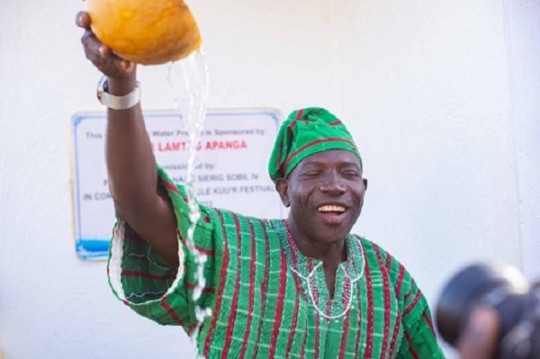 Lamtiig Apanga with a calabash of water after the inaugurationover