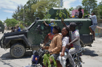 Residents of Cité Soleil welcome armored police vehicles during a protest in Port-au-Prince