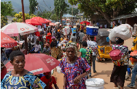 Congolese civilians walk at Maendeleo market as calm returns after clashes between AFC and M23