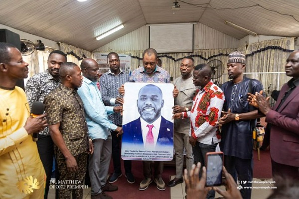 The group presented Dr. Matthew Opoku Prempeh with an artwork of his image and items