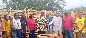 Kwaku Kwarteng handing over the desks to the schools