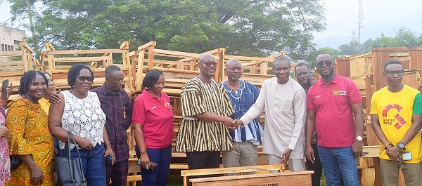 Kwaku Kwarteng handing over the desks to the schools