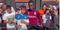 Owusu Amando in (tracksuit) taking pictures with the Valencia fans