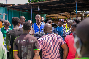 Frank Nkansah (in blue vest) is seen here interacting with some of the traders