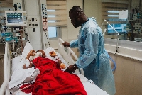 Gerald Asamoah with one of the children who was operated on