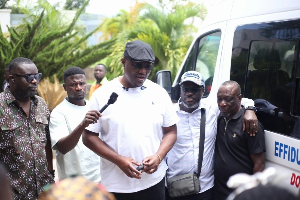 A picture of  Dr Nana Ayew Afriye speaking with his constituent