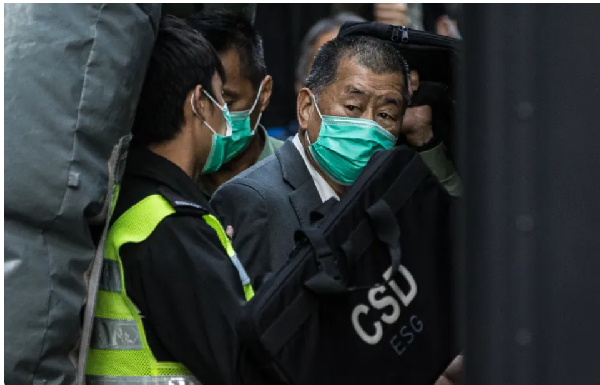 Media tycoon Jimmy Lai is escorted into a Hong Kong Correctional Services van outside the Court